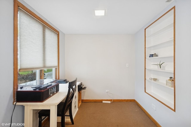 carpeted home office featuring baseboards