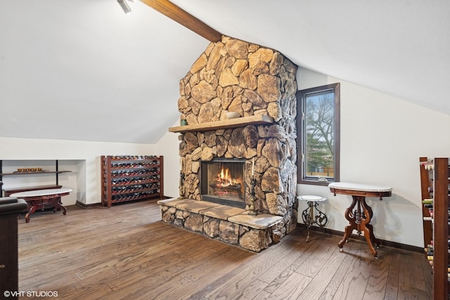 living room with hardwood / wood-style flooring, baseboards, and a fireplace