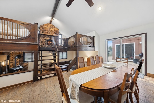 dining space featuring baseboards, wood-type flooring, and a ceiling fan