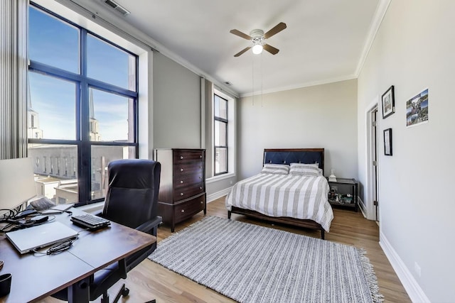 4440 N Kedzie Ave Unit 401, Chicago, IL 60625 - bedroom featuring crown molding, wood finished floors, baseboards, a desk, and a ceiling fan