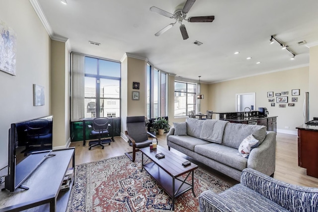 4440 N Kedzie Ave Unit 401, Chicago, IL 60625 - living area with light wood-style flooring, ornamental molding, a desk, a ceiling fan, and baseboards