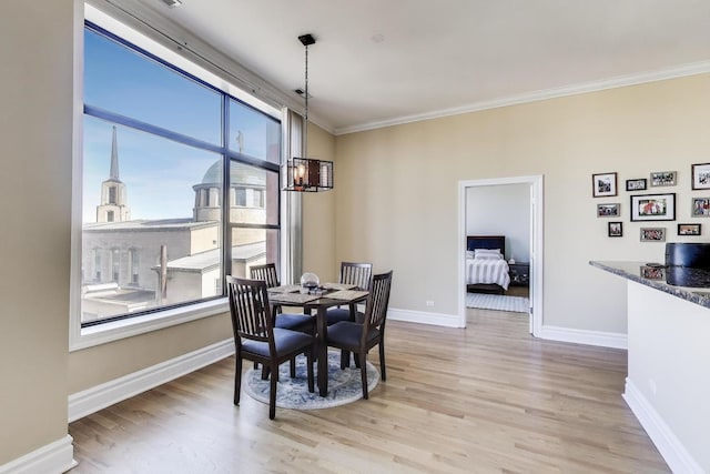 4440 N Kedzie Ave Unit 401, Chicago, IL 60625 - dining space with a chandelier, ornamental molding, wood finished floors, and baseboards