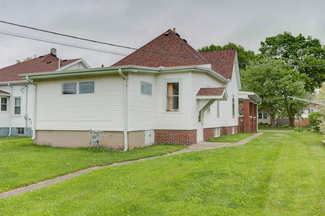 206 N Pine St, Villa Grove, IL 61956 - view of property exterior with a yard and a shingled roof
