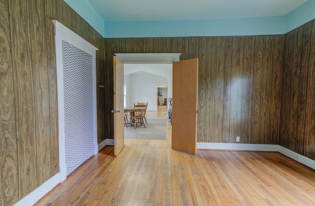 206 N Pine St, Villa Grove, IL 61956 - spare room featuring arched walkways, hardwood / wood-style flooring, and baseboards