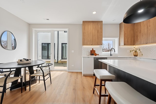 944 Beloit Ave Unit 2, Forest Park, IL 60130 - kitchen featuring dishwasher, modern cabinets, light countertops, a kitchen breakfast bar, and recessed lighting