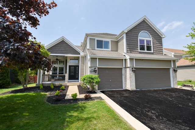 1112 Laurel Ln, Gurnee, IL 60031 - view of front of home with a porch, a front yard, a garage, driveway, and a ceiling fan