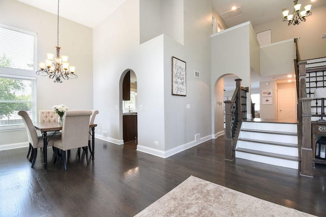 1112 Laurel Ln, Gurnee, IL 60031 - dining room with arched walkways, a chandelier, high vaulted ceiling, wood finished floors, and baseboards