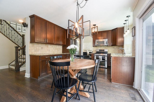 1112 Laurel Ln, Gurnee, IL 60031 - kitchen with stainless steel appliances, dark wood finished floors, backsplash, and light stone countertops