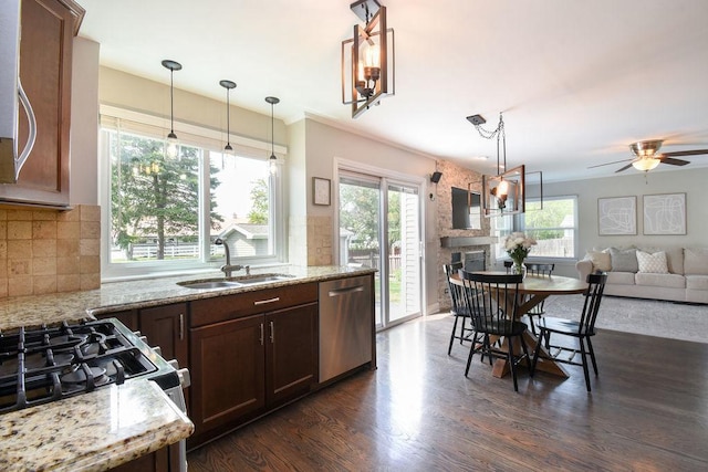 1112 Laurel Ln, Gurnee, IL 60031 - kitchen with stainless steel dishwasher, a sink, range with gas cooktop, hanging light fixtures, and dark wood-style floors