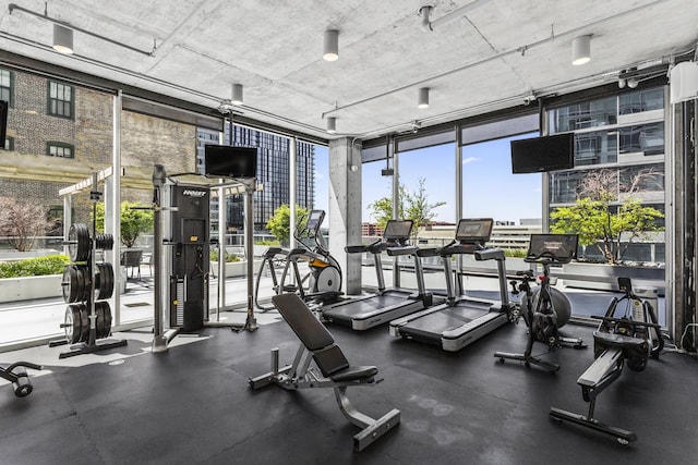 gym with a wall of windows