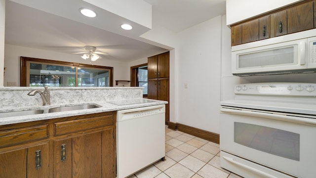 321 E Chamberlin St, Dixon, IL 61021 - kitchen featuring white appliances, a sink, light tile patterned flooring, baseboards, and ceiling fan
