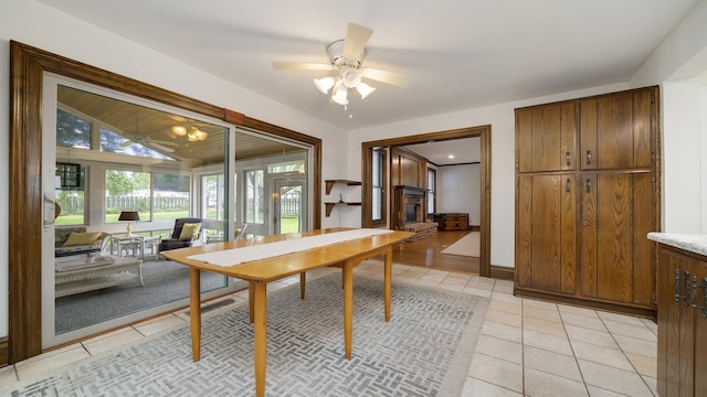 321 E Chamberlin St, Dixon, IL 61021 - dining area with ceiling fan, light tile patterned floors, a brick fireplace, and lofted ceiling