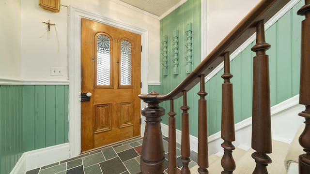321 E Chamberlin St, Dixon, IL 61021 - entrance foyer featuring stairway, a wainscoted wall, and ornamental molding