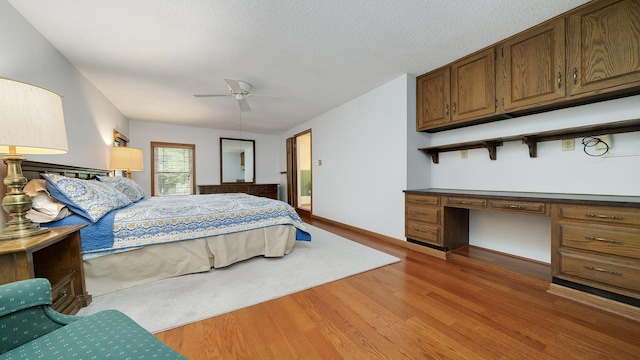 321 E Chamberlin St, Dixon, IL 61021 - bedroom with light wood-style flooring, a textured ceiling, and baseboards
