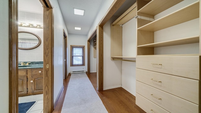 321 E Chamberlin St, Dixon, IL 61021 - spacious closet featuring baseboard heating, dark wood finished floors, and a sink