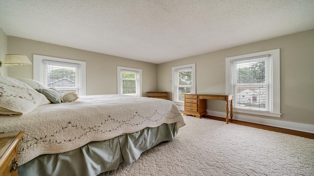 321 E Chamberlin St, Dixon, IL 61021 - bedroom featuring wood finished floors, baseboards, and a textured ceiling