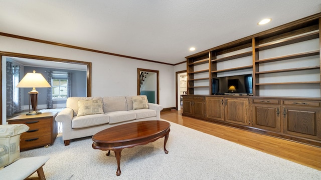 321 E Chamberlin St, Dixon, IL 61021 - living area featuring light wood-style floors, recessed lighting, baseboards, ornamental molding, and a textured ceiling