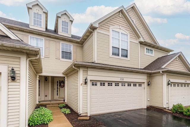 722 Amherst Dr, Sycamore, IL 60178 - view of property featuring asphalt driveway and a garage