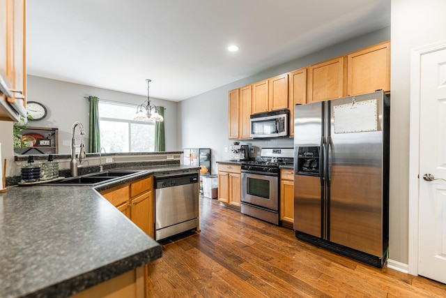 722 Amherst Dr, Sycamore, IL 60178 - kitchen with stainless steel appliances, dark countertops, a sink, recessed lighting, and a chandelier