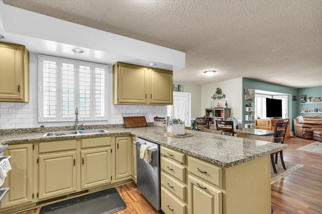 705 Northridge Dr, Mahomet, IL 61853 - kitchen with dishwasher, a peninsula, open floor plan, light wood-type flooring, and a textured ceiling