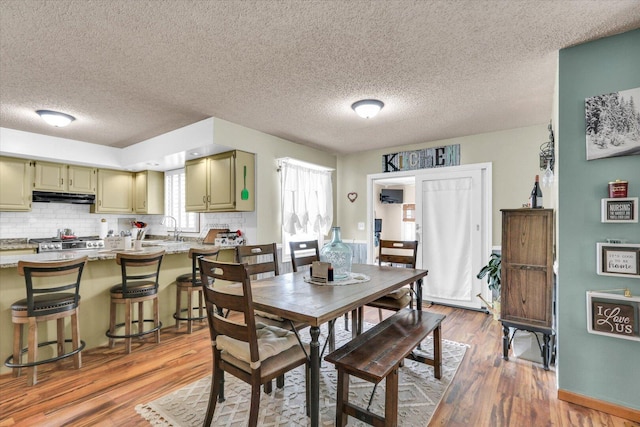 705 Northridge Dr, Mahomet, IL 61853 - dining space with light wood-style flooring and a textured ceiling