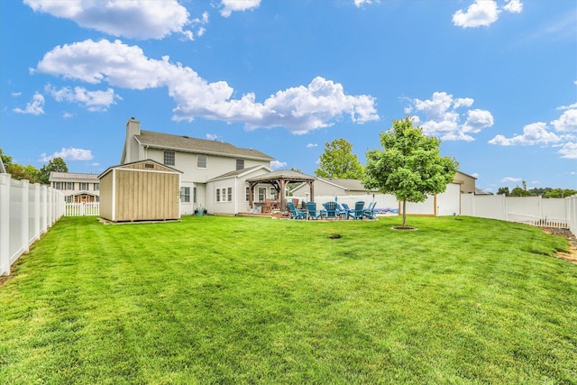 705 Northridge Dr, Mahomet, IL 61853 - rear view of property with a gazebo, a storage unit, a chimney, and a fenced backyard