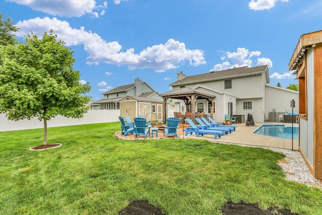 705 Northridge Dr, Mahomet, IL 61853 - back of property featuring a gazebo, a patio area, a shed, and a chimney