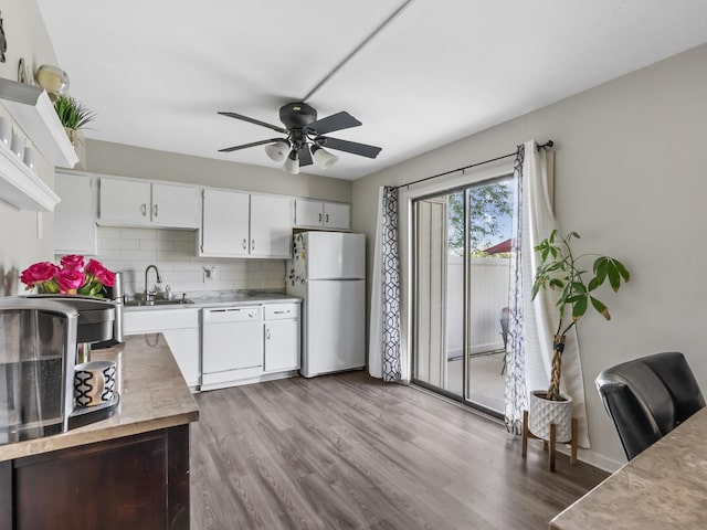 1094 Rainwood Dr, Aurora, IL 60506 - kitchen featuring white appliances, a sink, wood finished floors, tasteful backsplash, and light countertops