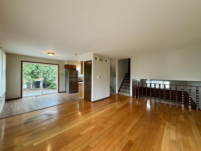 16104 Oak Ave, Oak Forest, IL 60452 - unfurnished living room featuring light wood finished floors and stairway