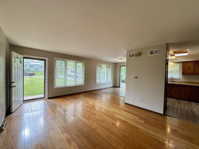 16104 Oak Ave, Oak Forest, IL 60452 - unfurnished living room with a sink and light wood-type flooring