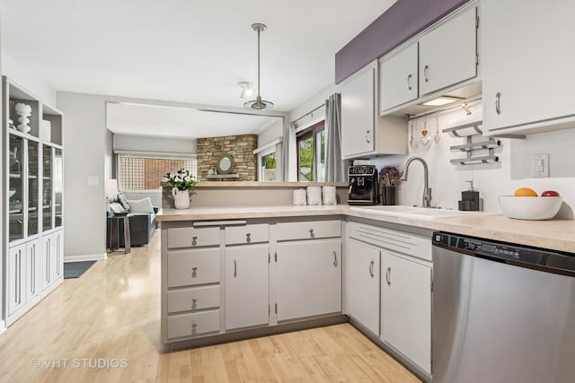 1140 Catalpa Ln, Naperville, IL 60540 - kitchen with stainless steel dishwasher, a sink, a peninsula, and light countertops