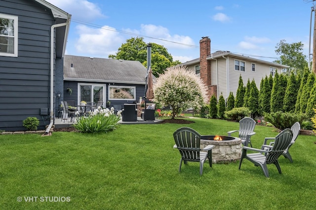 1140 Catalpa Ln, Naperville, IL 60540 - view of grassy yard with a fire pit and a patio area