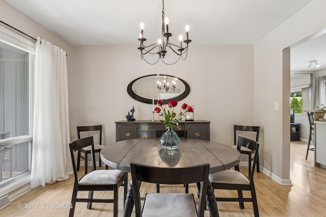 1140 Catalpa Ln, Naperville, IL 60540 - dining room featuring a chandelier, light wood finished floors, and baseboards