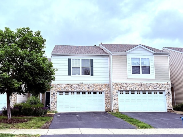 4078 Boulder Ct, Aurora, IL 60504 - view of front of home featuring driveway, stone siding, and an attached garage
