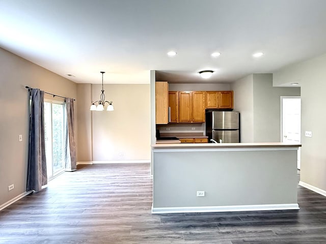 4078 Boulder Ct, Aurora, IL 60504 - kitchen with freestanding refrigerator, a chandelier, baseboards, brown cabinets, and dark wood-type flooring
