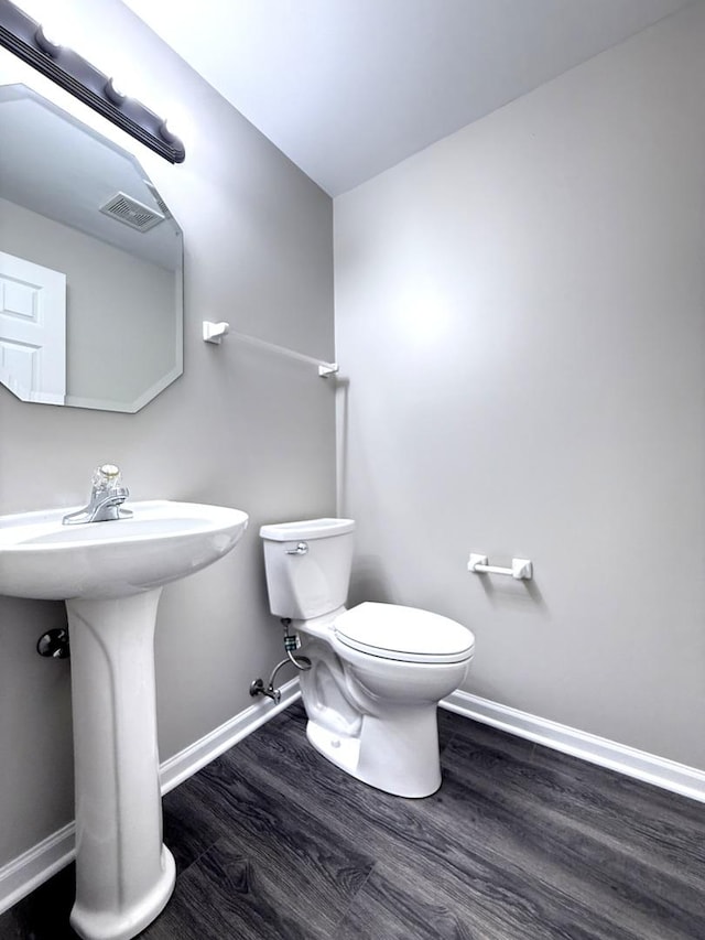 4078 Boulder Ct, Aurora, IL 60504 - bathroom featuring wood finished floors, baseboards, toilet, and a sink