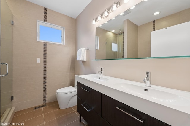 3019 N Allen Ave, Chicago, IL 60618 - full bathroom with a stall shower, toilet, double vanity, and tile patterned flooring