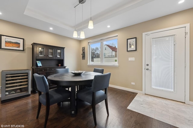 3019 N Allen Ave, Chicago, IL 60618 - dining area with wine cooler, a raised ceiling, recessed lighting, baseboards, and dark wood-style floors