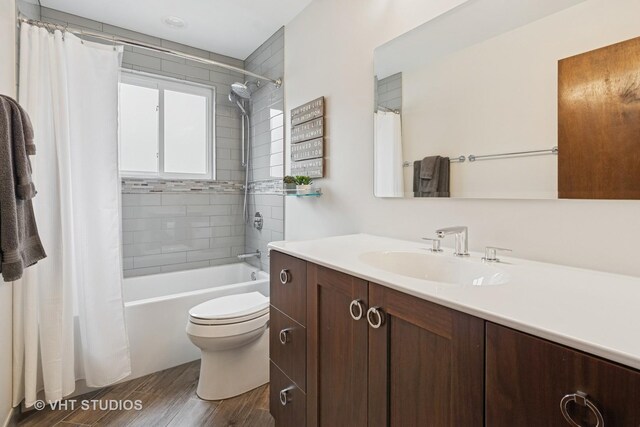 1809 Grant St, Evanston, IL 60201 - bathroom with vanity, toilet, wood finished floors, and shower / bath combo with shower curtain