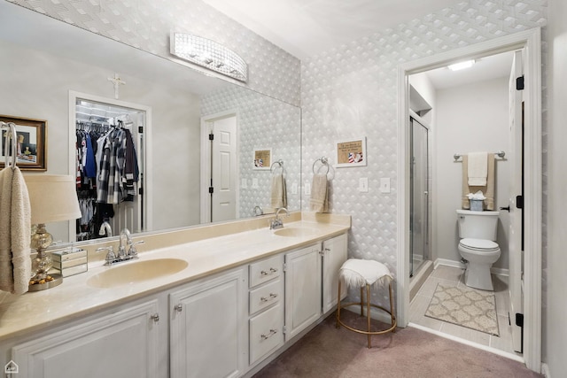 36 Lakewood Cir, Saint Charles, IL 60174 - full bath featuring a shower stall, toilet, double vanity, wallpapered walls, and a spacious closet