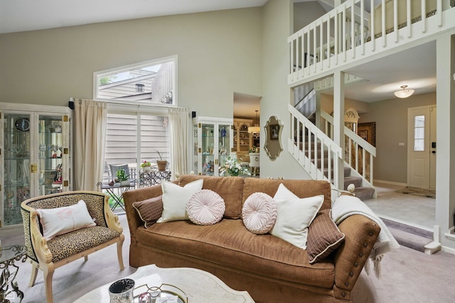 36 Lakewood Cir, Saint Charles, IL 60174 - living room featuring high vaulted ceiling, stairs, carpet floors, and baseboards