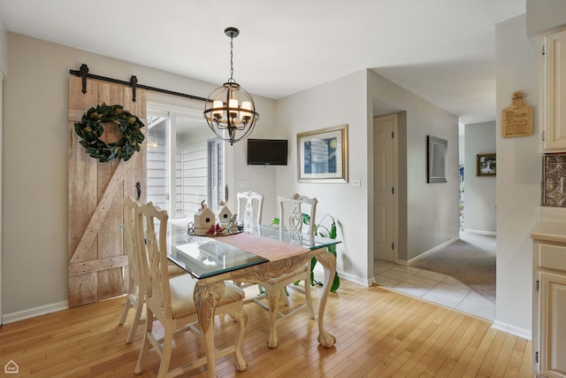 36 Lakewood Cir, Saint Charles, IL 60174 - dining area with light wood-type flooring, baseboards, a chandelier, and a barn door