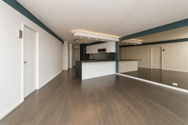 300 N State St Unit 5503, Chicago, IL 60654 - unfurnished living room featuring a sink, dark wood-type flooring, recessed lighting, and baseboards