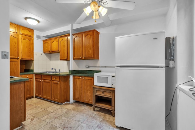 7204 Oak Ave Unit 1Nw, River Forest, IL 60305 - kitchen with white appliances, a sink, brown cabinets, a ceiling fan, and dark countertops