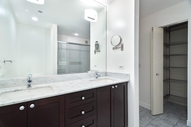 737 W Washington Blvd Unit 2702, Chicago, IL 60661 - full bathroom with a shower stall, double vanity, marble look tile flooring, and baseboards