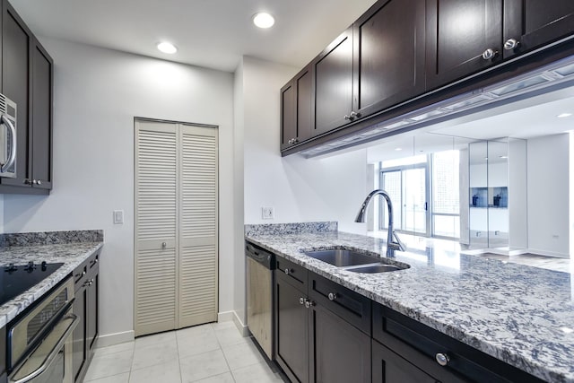 737 W Washington Blvd Unit 2702, Chicago, IL 60661 - kitchen with a sink, wall oven, stainless steel dishwasher, baseboards, and light stone countertops
