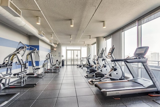 737 W Washington Blvd Unit 2702, Chicago, IL 60661 - workout area featuring plenty of natural light and a textured ceiling
