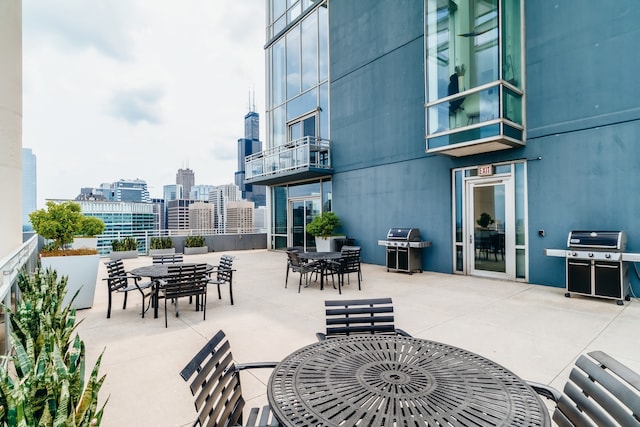 737 W Washington Blvd Unit 2702, Chicago, IL 60661 - view of patio featuring a view of skyline, a grill, and outdoor dining space