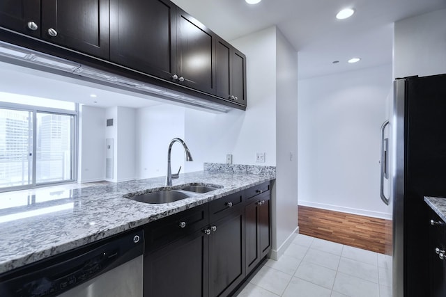 737 W Washington Blvd Unit 2702, Chicago, IL 60661 - kitchen featuring stainless steel appliances, a sink, light tile patterned floors, light stone countertops, and recessed lighting