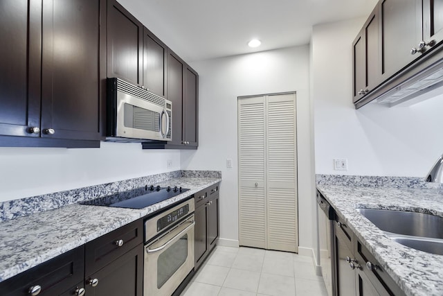 737 W Washington Blvd Unit 2702, Chicago, IL 60661 - kitchen featuring stainless steel appliances, a sink, light tile patterned floors, baseboards, and light stone countertops